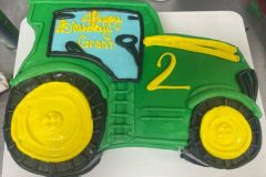 Cutout green tractor cake